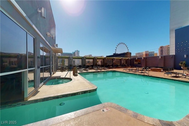 view of swimming pool featuring a patio and a community hot tub