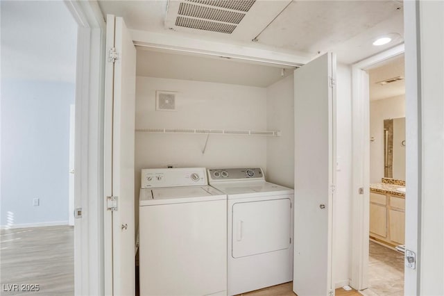 washroom with independent washer and dryer