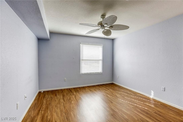 empty room featuring hardwood / wood-style flooring, ceiling fan, and a textured ceiling