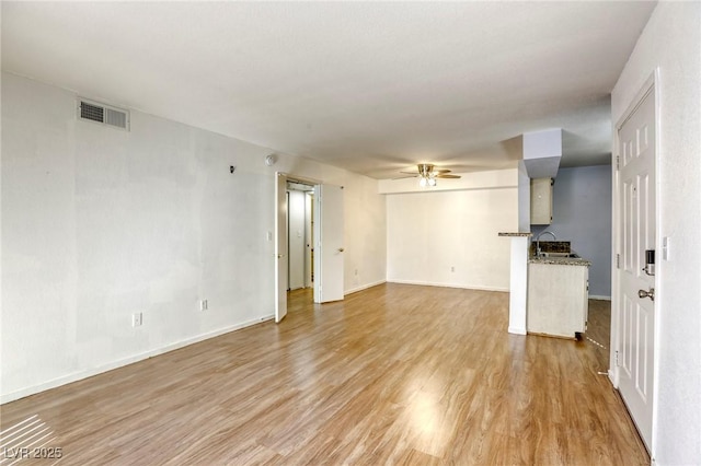 unfurnished living room featuring light hardwood / wood-style floors and ceiling fan