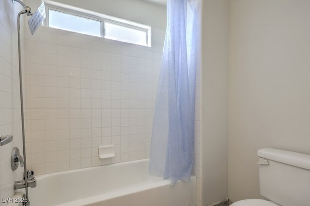 bathroom featuring toilet and shower / tub combo