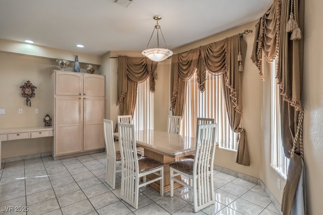 unfurnished dining area with light tile patterned flooring