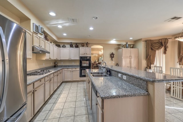 kitchen with a center island, appliances with stainless steel finishes, sink, and a kitchen bar