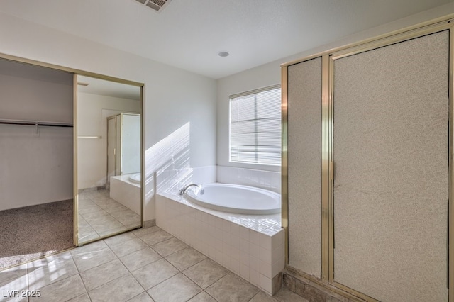 bathroom with tile patterned floors and independent shower and bath