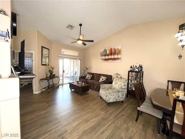 living room featuring ceiling fan, dark hardwood / wood-style flooring, and vaulted ceiling