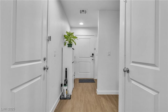 hallway with light hardwood / wood-style flooring