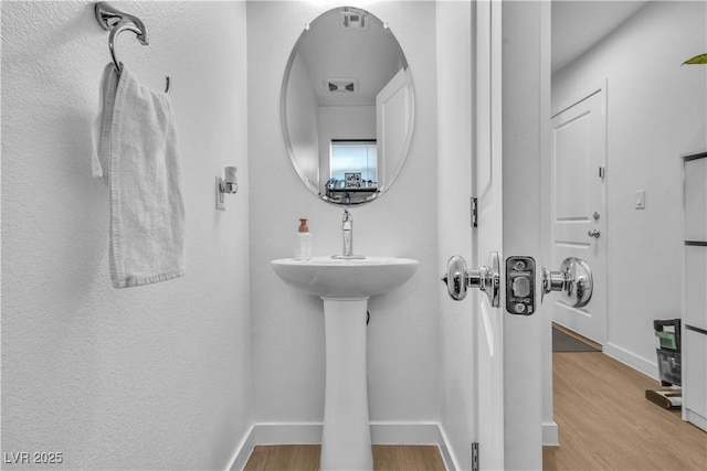 bathroom with hardwood / wood-style floors