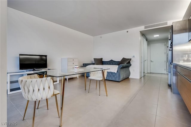 interior space featuring light tile patterned floors and visible vents