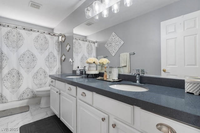 bathroom featuring vanity and toilet