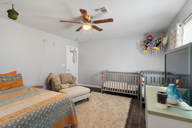 bedroom with ceiling fan and dark hardwood / wood-style flooring