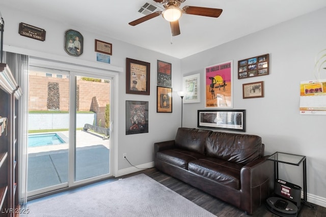 living room featuring hardwood / wood-style floors and ceiling fan