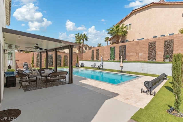 view of swimming pool featuring ceiling fan and a patio area