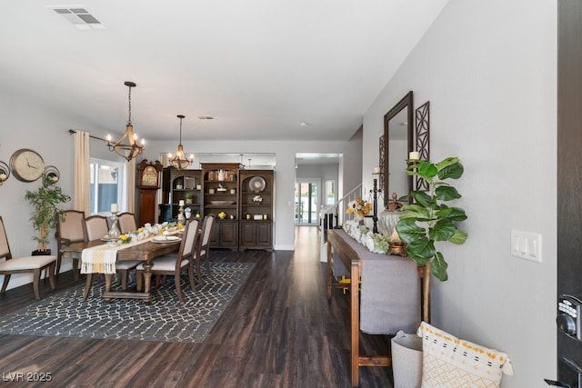 dining room with an inviting chandelier and dark hardwood / wood-style floors