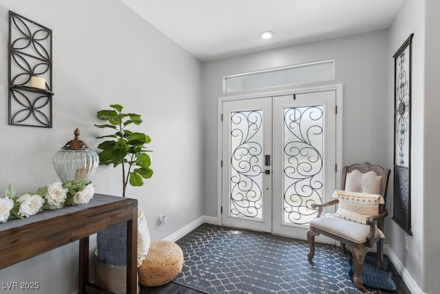 foyer with dark carpet and french doors