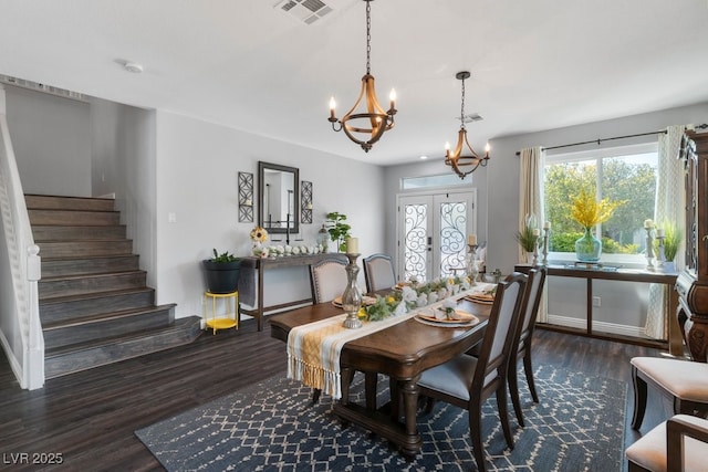 dining room featuring dark hardwood / wood-style flooring and a chandelier