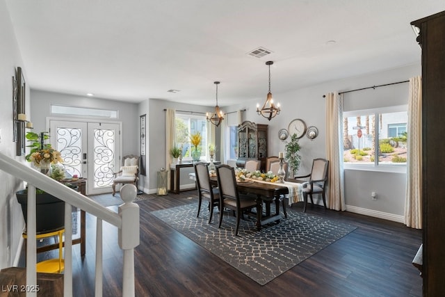 dining area with plenty of natural light, dark wood-type flooring, and french doors