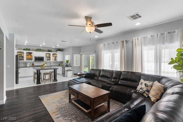 living room featuring hardwood / wood-style flooring and ceiling fan