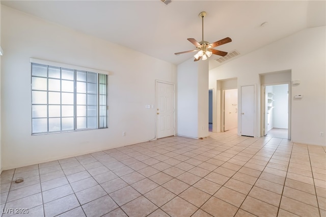 unfurnished room with lofted ceiling, light tile patterned floors, and ceiling fan