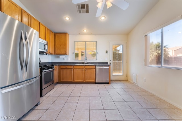 kitchen featuring ceiling fan, appliances with stainless steel finishes, sink, and light tile patterned floors