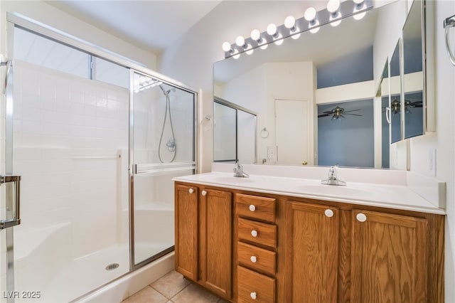 bathroom with vanity, a shower with shower door, and tile patterned flooring