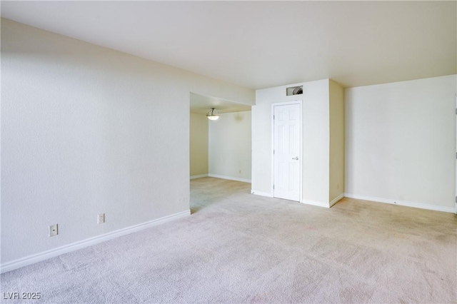 unfurnished room featuring light colored carpet