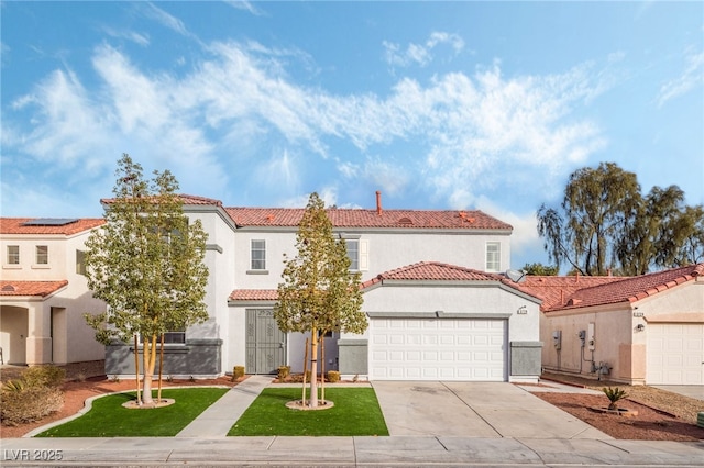 mediterranean / spanish home with a garage