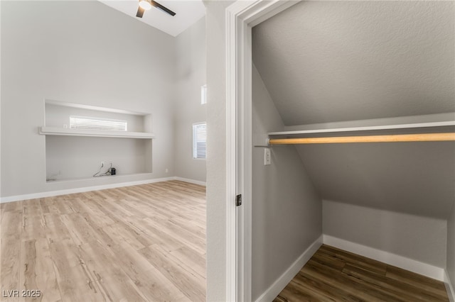 laundry area featuring wood-type flooring and ceiling fan