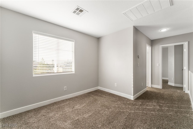 unfurnished room featuring dark carpet