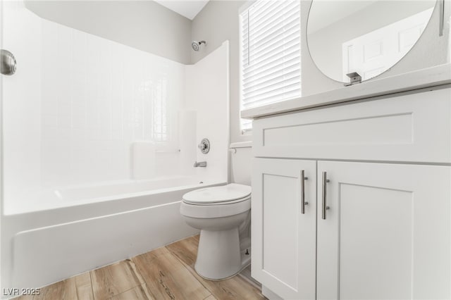 bathroom featuring hardwood / wood-style floors, bathtub / shower combination, and toilet