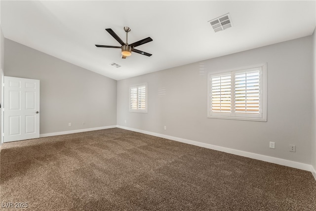 spare room with vaulted ceiling, carpet flooring, and ceiling fan