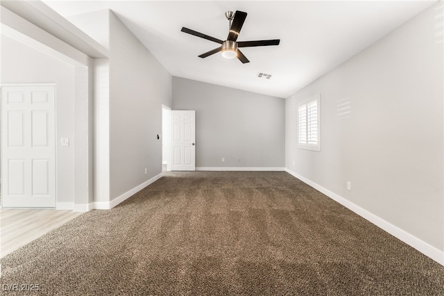 spare room featuring ceiling fan, lofted ceiling, and carpet