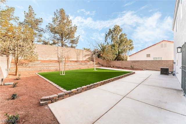 view of yard with a patio and central air condition unit