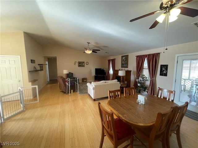 dining room featuring light hardwood / wood-style flooring and vaulted ceiling