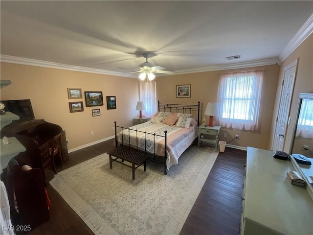 bedroom featuring crown molding, dark wood-type flooring, and ceiling fan