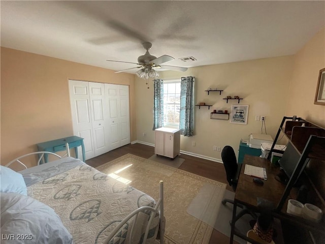 bedroom featuring dark hardwood / wood-style flooring, a closet, and ceiling fan