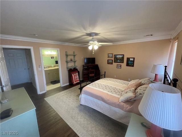 bedroom with crown molding, dark wood-type flooring, ensuite bathroom, and ceiling fan