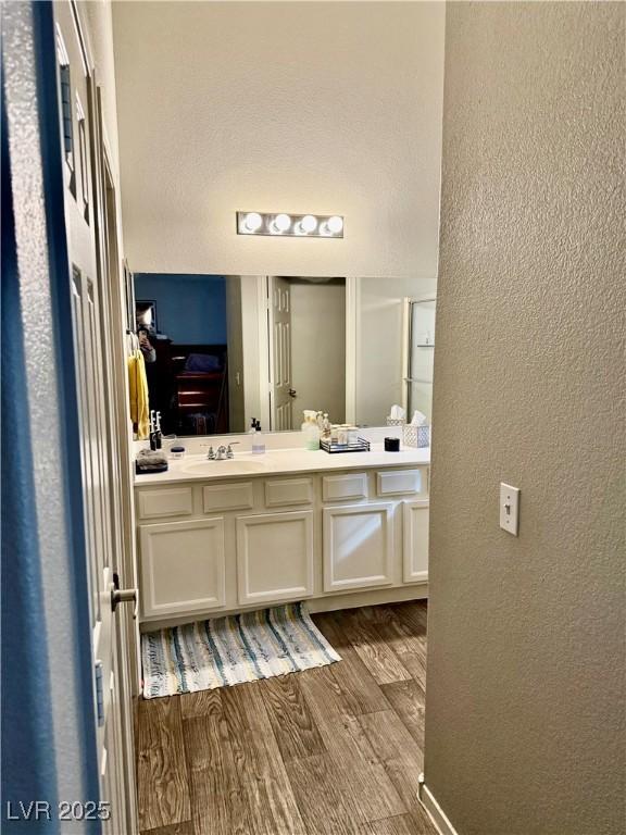 bathroom featuring vanity and hardwood / wood-style floors