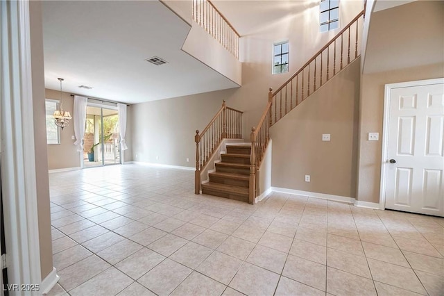 interior space with tile patterned flooring, a high ceiling, and an inviting chandelier