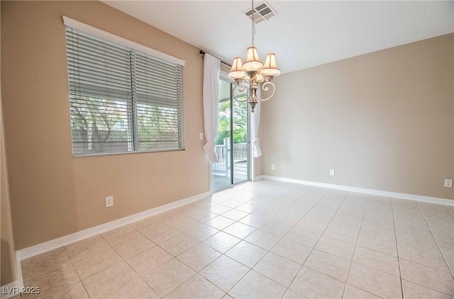 unfurnished room with light tile patterned flooring and a chandelier