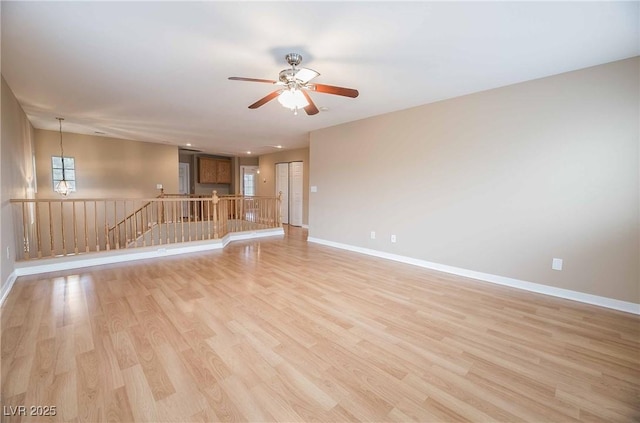 unfurnished living room with ceiling fan and light wood-type flooring