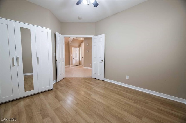 unfurnished bedroom featuring light hardwood / wood-style floors, a closet, and ceiling fan