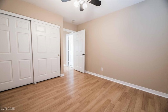 unfurnished bedroom featuring ceiling fan, light hardwood / wood-style floors, and a closet