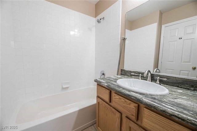 bathroom featuring vanity and tiled shower / bath combo