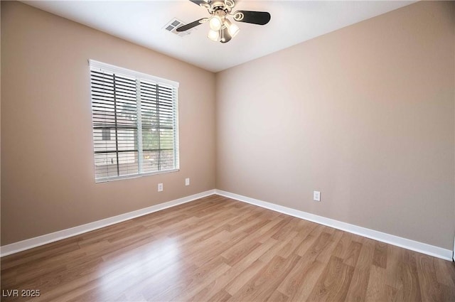 empty room with ceiling fan and light hardwood / wood-style floors