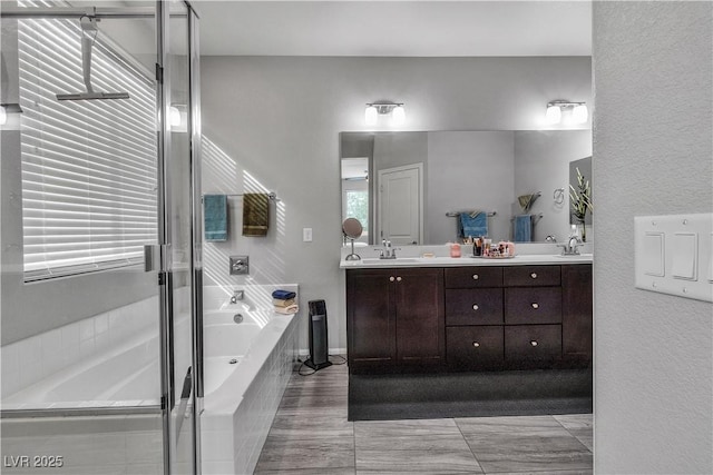 bathroom with vanity and separate shower and tub