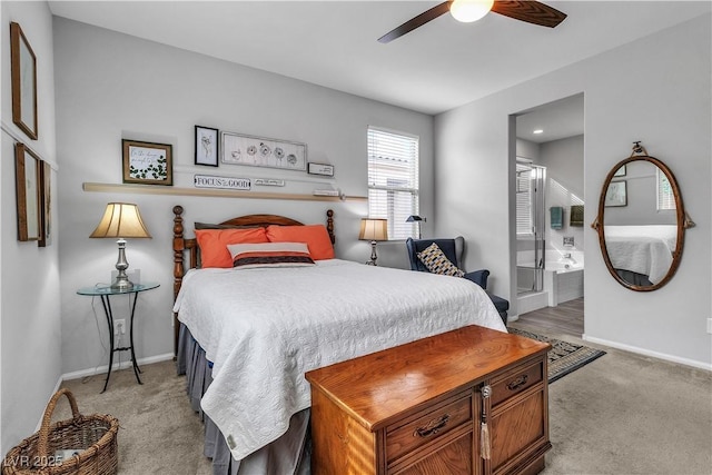 bedroom featuring ensuite bathroom, light carpet, and ceiling fan