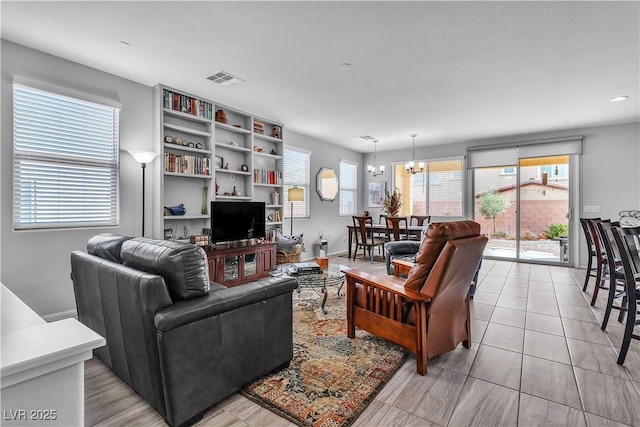 tiled living room with a chandelier