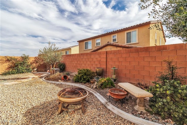 view of yard with a fire pit