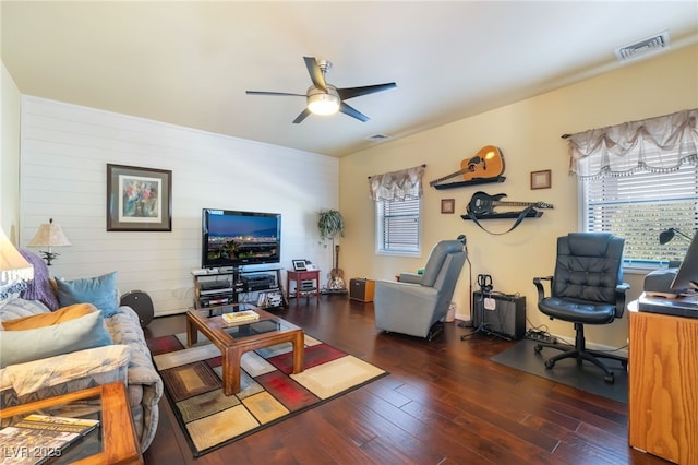 living room with ceiling fan and dark hardwood / wood-style flooring