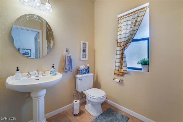 bathroom featuring tile patterned floors and toilet